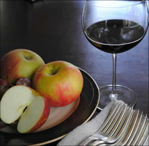 Glass or red wine with plate of fruit