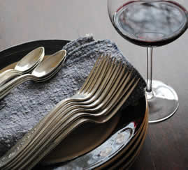 Glass of red wine with dinner plates