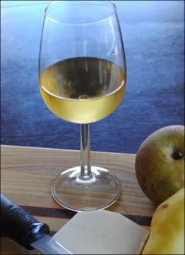 glass of white wine with fruit plate